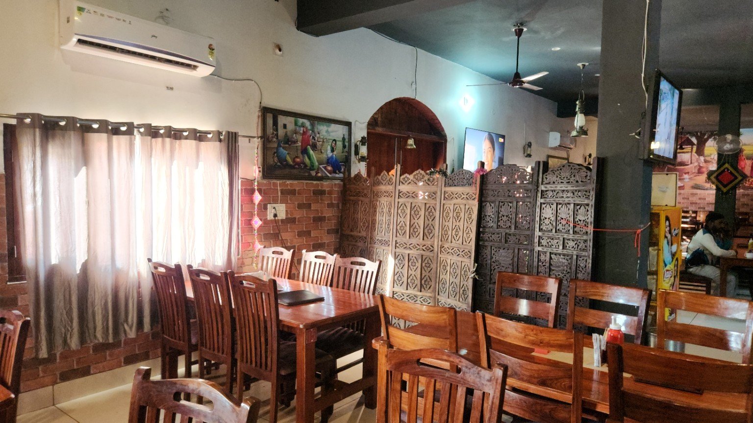 Wooden tables and carved screens in the dining room.